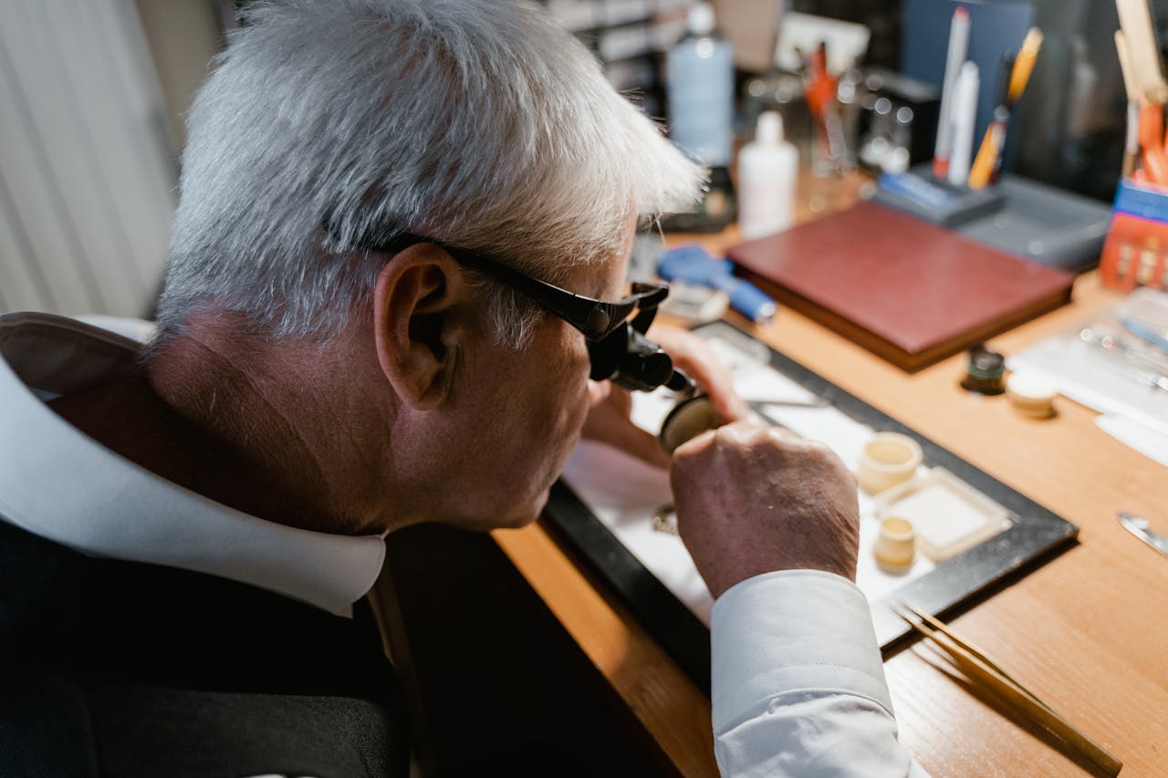 Watchmaker examining a luxury timepiece to confirm its authenticity